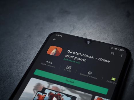Lod, Israel - July 8, 2020: Autodesk SketchBook - draw and paint app play store page on the display of a black mobile smartphone on a dark marble stone background. Top view flat lay with copy space.