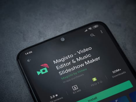 Lod, Israel - July 8, 2020: Magisto - Video Editor and Movie Maker app play store page on the display of a black mobile smartphone on a dark marble stone background. Top view flat lay with copy space.