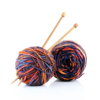 Two balls of wool with wooden knitting needles