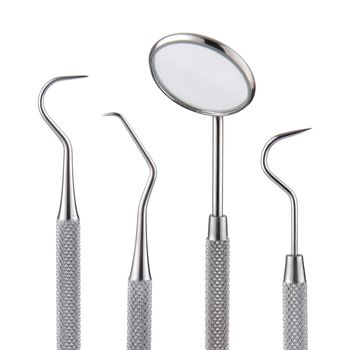 A set of dental tools. Mirror scaler and sickle probe dental explorer on white