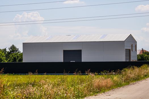 Big metal industrial storage shed building.  Exterior of warehouse, no brands on storehouse with copy space.