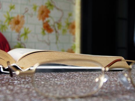 Open book on the table with reading glasses, Hobbies and studies