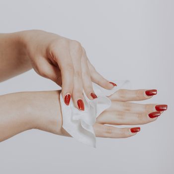 Young woman clean hands with wet wipes