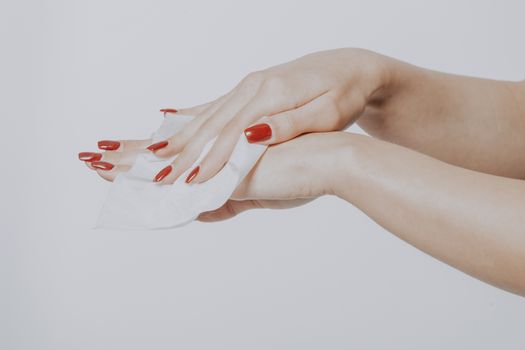 Young woman clean hands with wet wipes