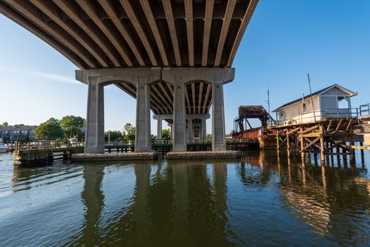 A wide angle photo looking up at a Shark river overpass by a drawbridge station in Belmar, NJ.
