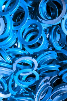 an abstract background of classic blue color coated metal ring parts.