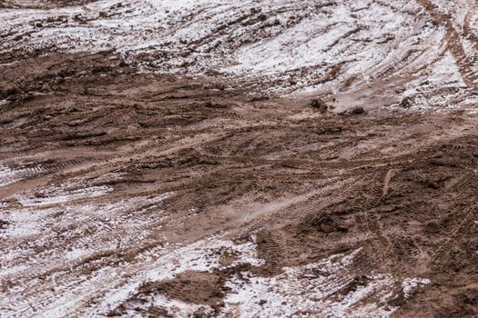 dirty mud road background at winter with selective focus and blur ft loudy weather