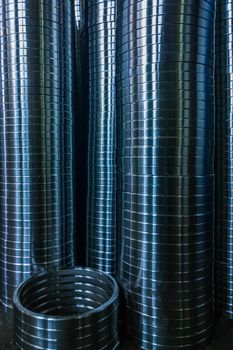 industrial manufacturing background of columns of shiny metal rings after cnc turning operation. Selective focus technique.