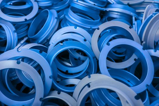 an abstract background of classic blue color coated metal ring parts.