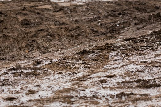 dirty mud road background at winter with selective focus and blur ft loudy weather