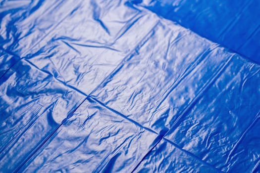 crumpled polyethilene film abstract background with selective focus.