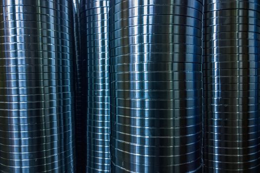 industrial manufacturing background of columns of shiny metal rings after cnc turning operation. Selective focus technique.