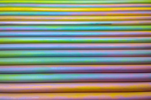 An abstract lines backround of colorful cadmium coated steel bars. Industrial grade chemical protective coating for metal parts.