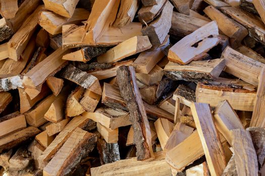 a pile of rustic birch firewood chunks.