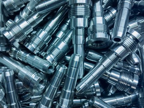shiny steel parts background, a pile of long steel rods after modern fine cnc turning cut.