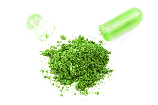 opened ufo green color organic med capsule isolated on white background closeup.
