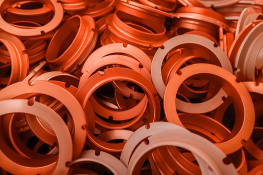 an abstract background of lush lava color coated metal ring parts.