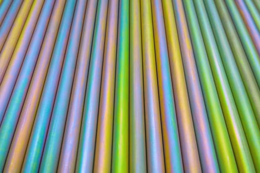 An abstract lines backround of colorful cadmium coated steel bars. Industrial grade chemical protective coating for metal parts.