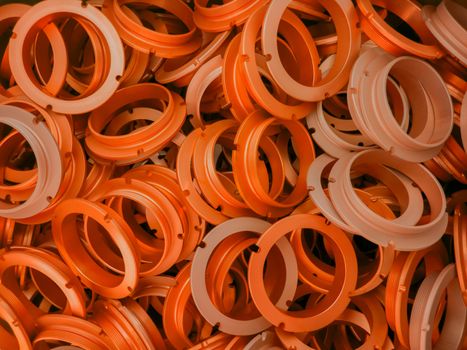 an abstract background of lush lava color coated metal ring parts.