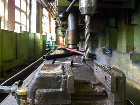 old drilling machine with obsolete used vice with selective focus.
