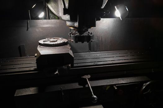 old manual milling machine in noir lighting style closeup with selective focus.