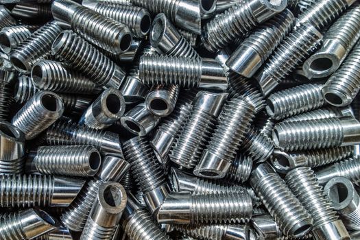 Shiiny metal car parts background with selective focus under direct sunlight.