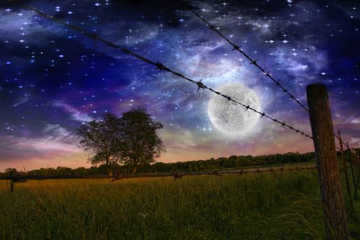 Starry night with bright moon and farmers fence in the field