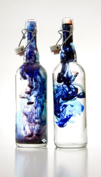 Two bottles with blue smoke