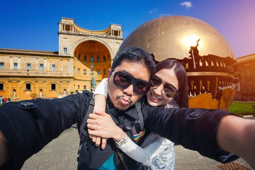 Young Couple Tourists selfie with mobile phone in Vatican, Italy