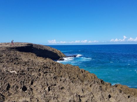 rocky shore with ocean water at beach in Isabela, Puerto Rico