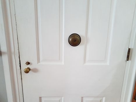 white wood door or entrance with knob and doorbell