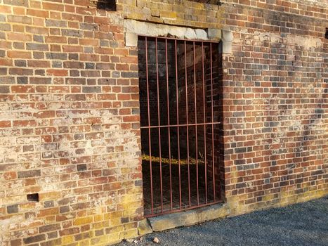 worn or weathered brick structure or ruins with metal door or bars