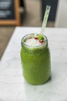 Green smoothie detox cleanse drink at cafe restaurant morning breakfast meal replacement for weight loss diet. Healthy eating lifestyle.