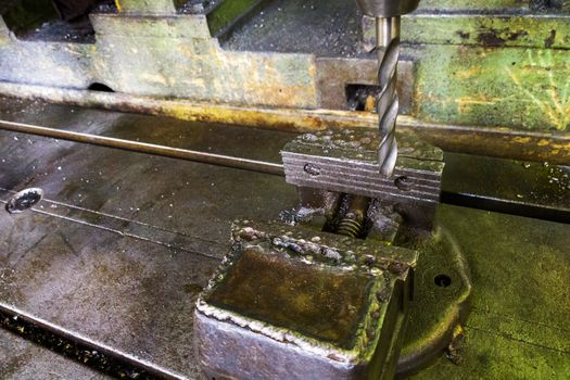 old drilling machine with obsolete used vice with selective focus.