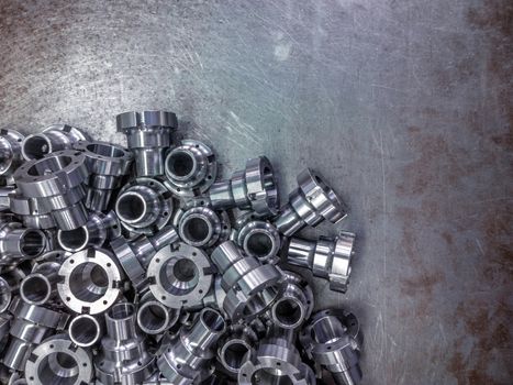 Shiny steel parts after cnc turning, drilling and machining on steel surface selective focus composition background.