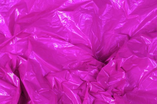 crumpled polyethilene film abstract background with selective focus.