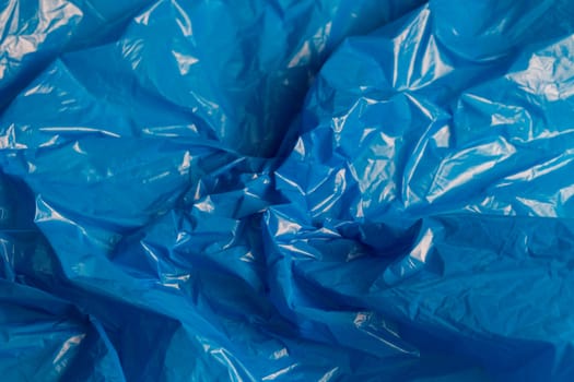 crumpled polyethilene film abstract background with selective focus.