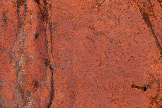 Weathered brown painted metal wall. Abstract background and rough texture.
