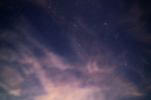 natural starry sky and motion blurred clouds background without montage.