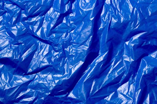 crumpled polyethilene film abstract background with selective focus.