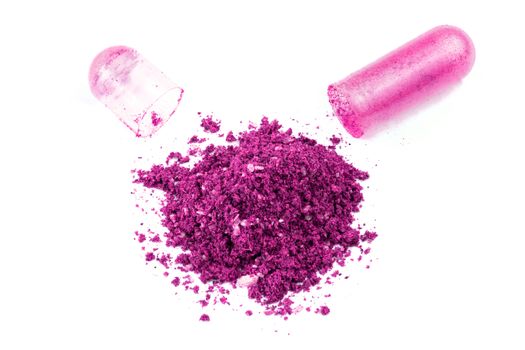 opened plastic pink color organic med capsule isolated on white background closeup.