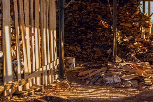 rustic firewood warehouse from inside at sundown sunlight.