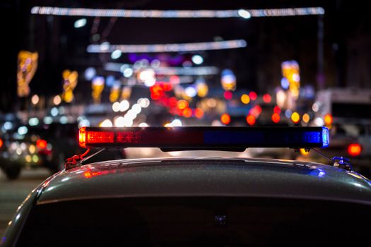 police car lights at night in city with selective focus and bokeh.