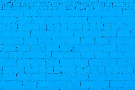 blue plaster rough brick wall texture under direct sunlight