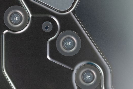 abstract metal tech background of shiny steel panel of computer hard disk drive unit.