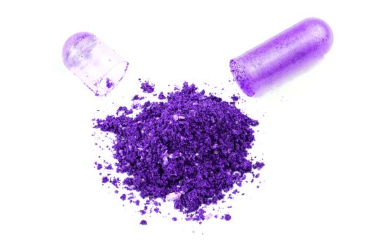 opened proton purple color organic med capsule isolated on white background closeup.