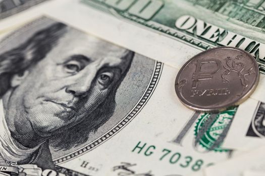 russian rubl coin over us dollar close-up with selective focus and blur