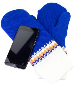 blue and white knited mittens with cellphone isolated on white background.