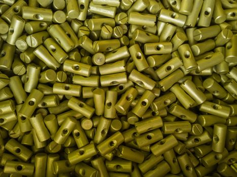 A batch of small sulfur oxidated anodized aluminium parts - mass production background