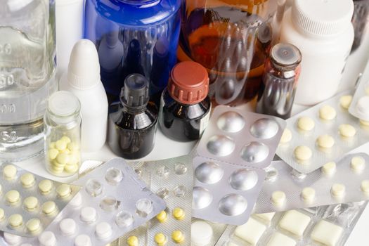 bunch casual of half-used and opened medial bottles and tablets with selective focus.